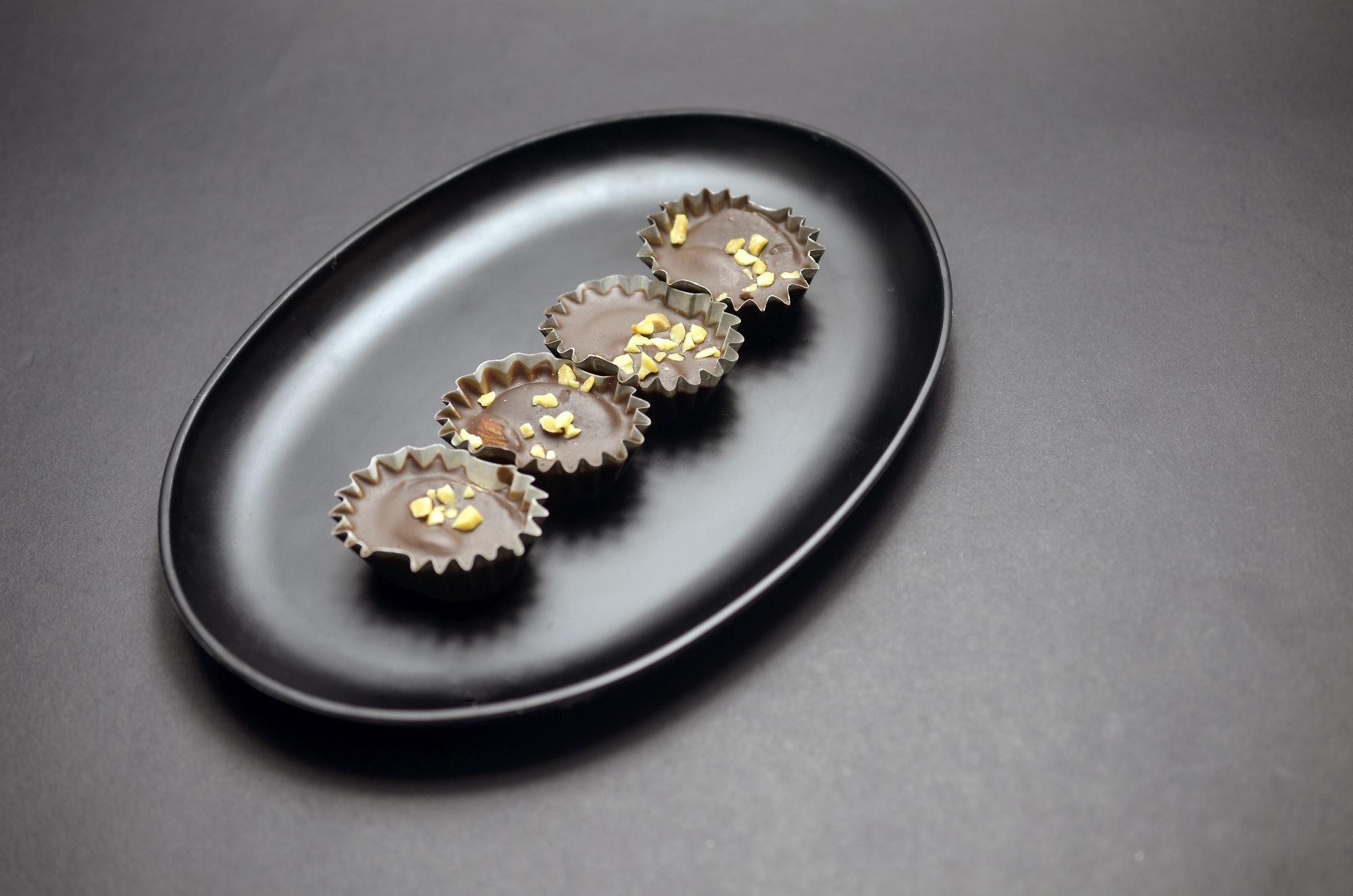 Large plated modern entrée on dark plate